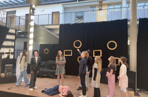Schüler auf einer Bühne, Theater spielend.
